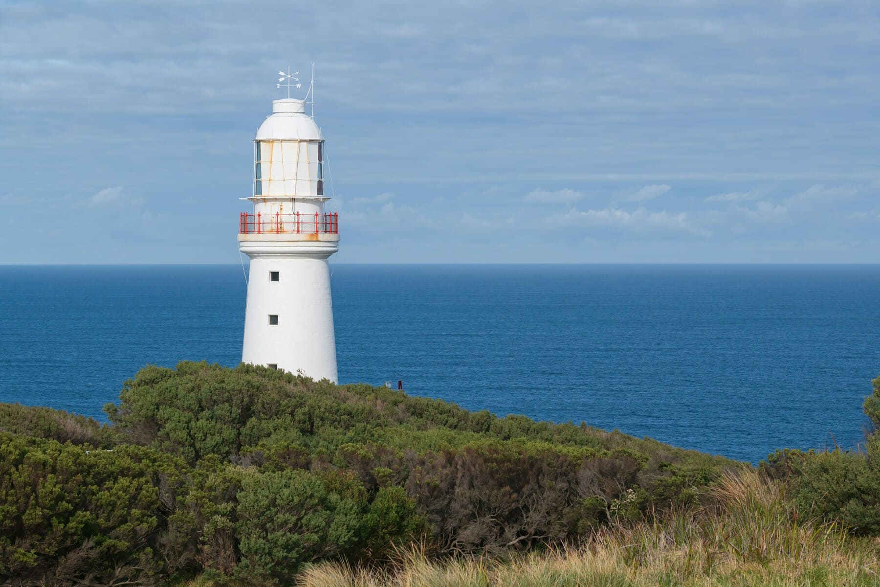 Cape Otway Lighthouse on top of a grassy hill in Victoria, Australia.